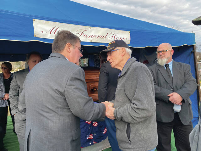 <p>Korean War veteran, Roy Lawson, pays his respect to the family of the late Army Cpl. Kenneth Ray Foreman during the funeral services at Mt. Orab Cemetery on Dec. 2. Photo by Wade Linville</p>