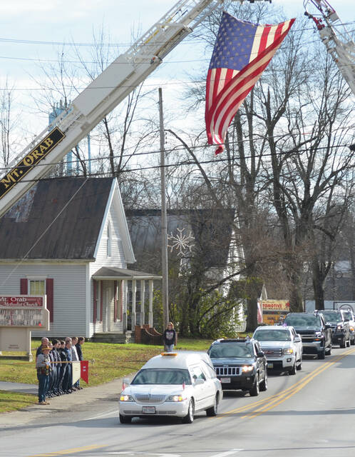 <p>People lined the streets of Mt. Orab to show their respect for Army Cpl. Kenneth Ray Foreman and his family during the funeral procession on Dec. 2. Photo by Wade Linville</p>