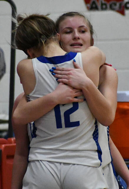 <p>Ripley’s lone senior, Reggie Taylor, hugs her sister, Grace (12), after checking out of the game on Senior Night.</p>