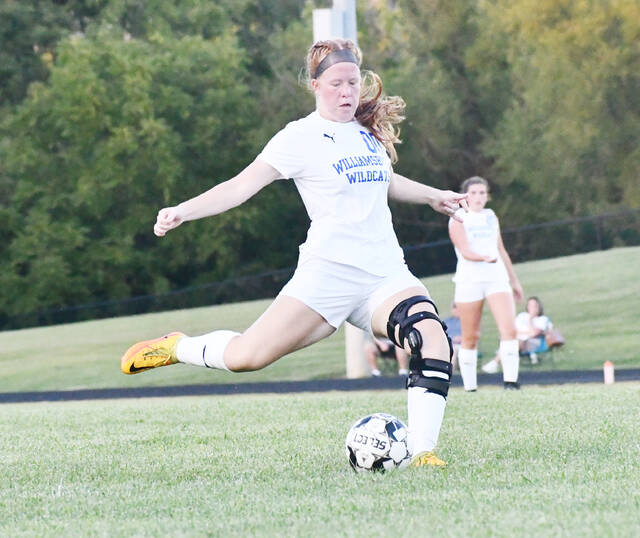 <p>Williamsburg’s Hope Arno kicks the ball into the box for the Lady Wildcats. Photo by Garth Shanklin.</p>