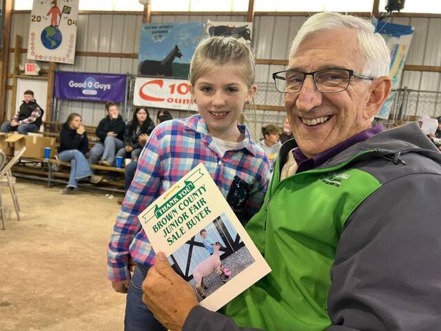 Paul Hall is pictured with a junior fair seller who he purchased an animal from at the Brown County Fair. Photo provided