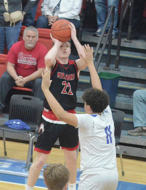Easterns Carter Cluxton drains a three-pointer during the Warriors Feb. 19 win at Ripley. Photo by Wade Linville