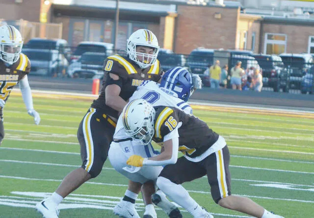 Western Browns Deon Bradford (No. 16) and Adam Pena (No. 0) take down a Chillicothe ball-carrier during their week three battle on Sept. 4. Photo by Wade Linville